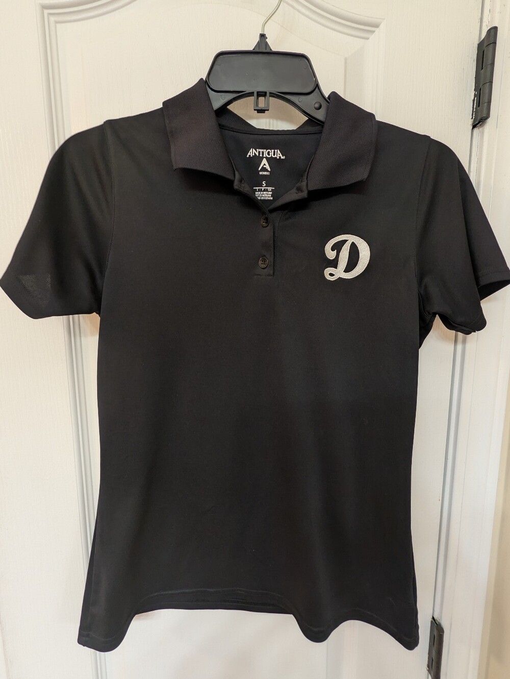 Antigua Women's Black Polo with White 'D' Initial Patch